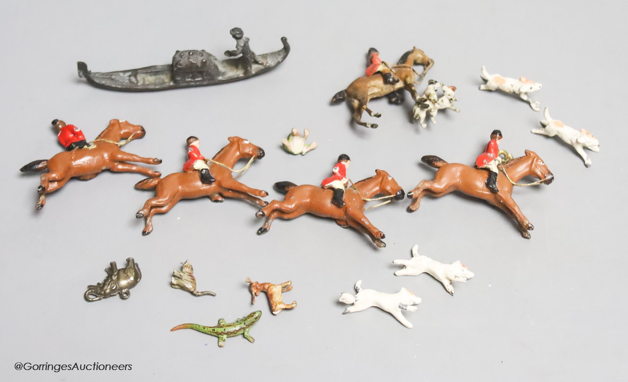 Four miniature cold-painted bronze animals, lizard, stag, frog and cat, a lead part hunting set, an elephant charm and a miniature bronze gondola